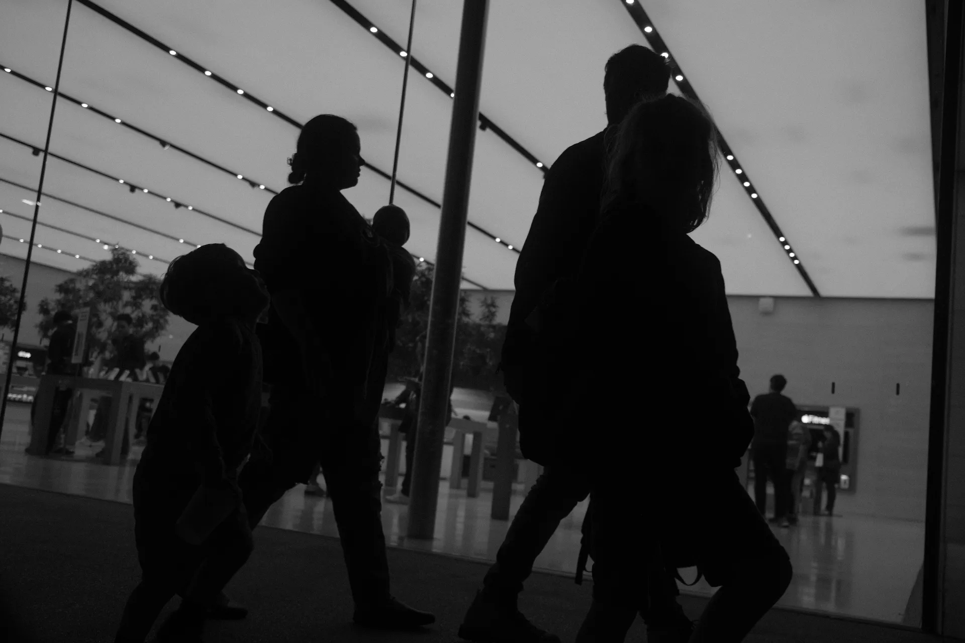 A family walking by an Apple Store