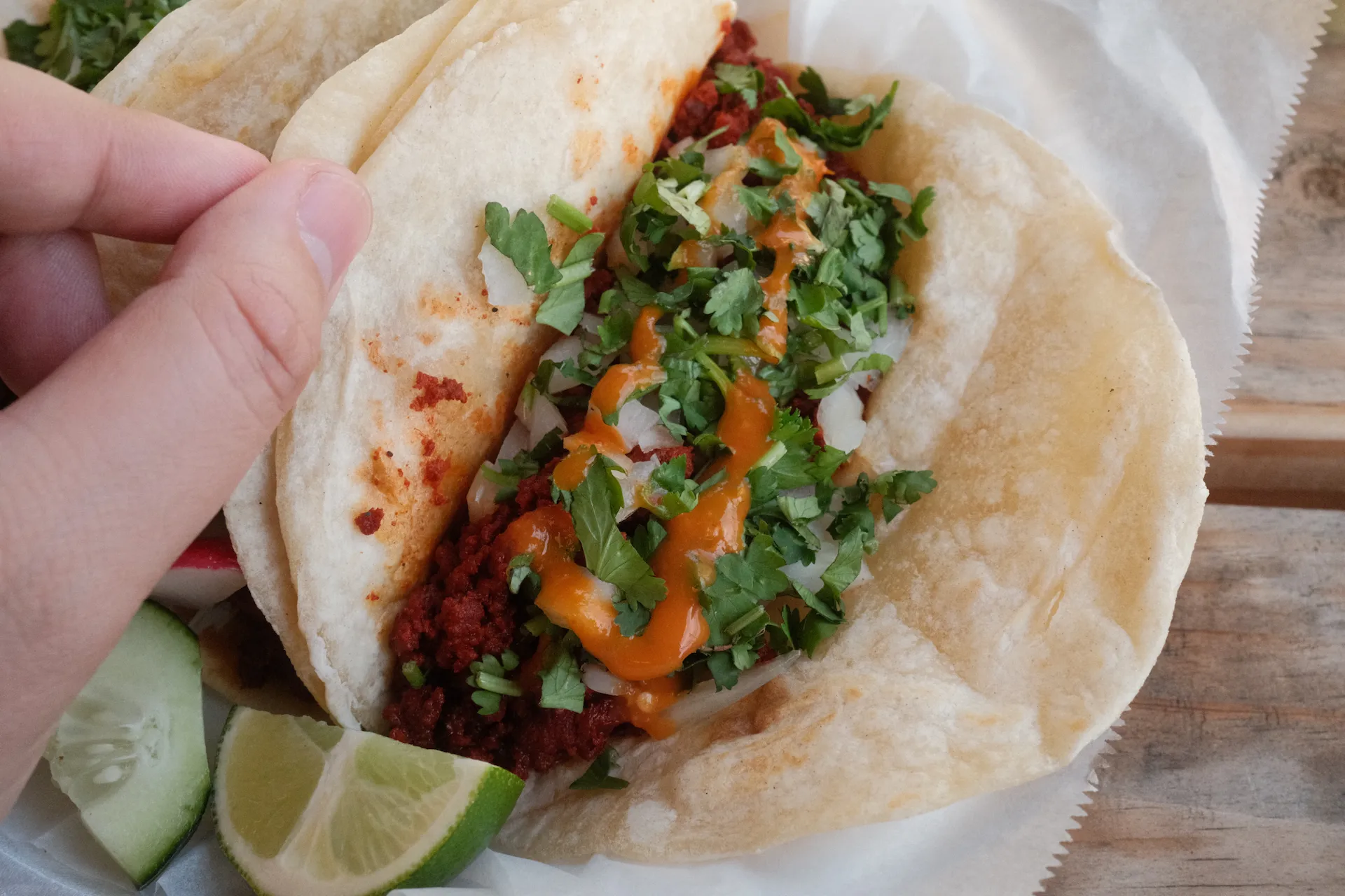 a close look at the inside of a chorizo taco with onions, cilantro and salso