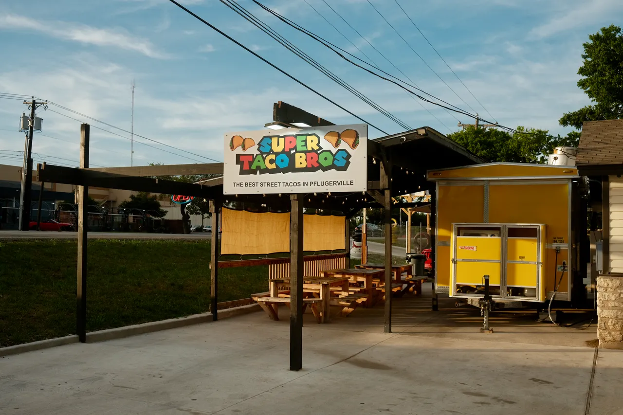 3 tacos on a wooden picnic table