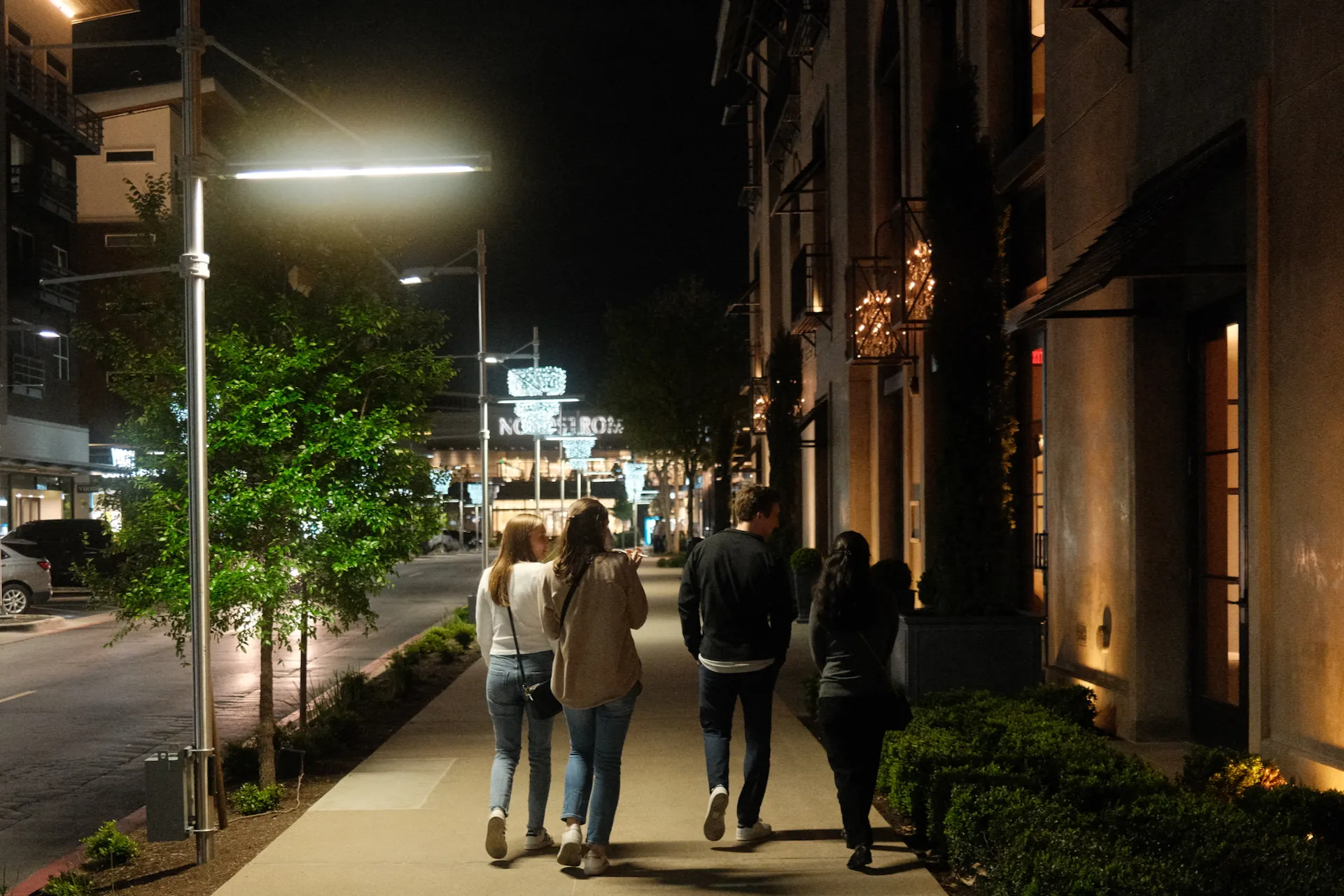 A group of friends walking down a street