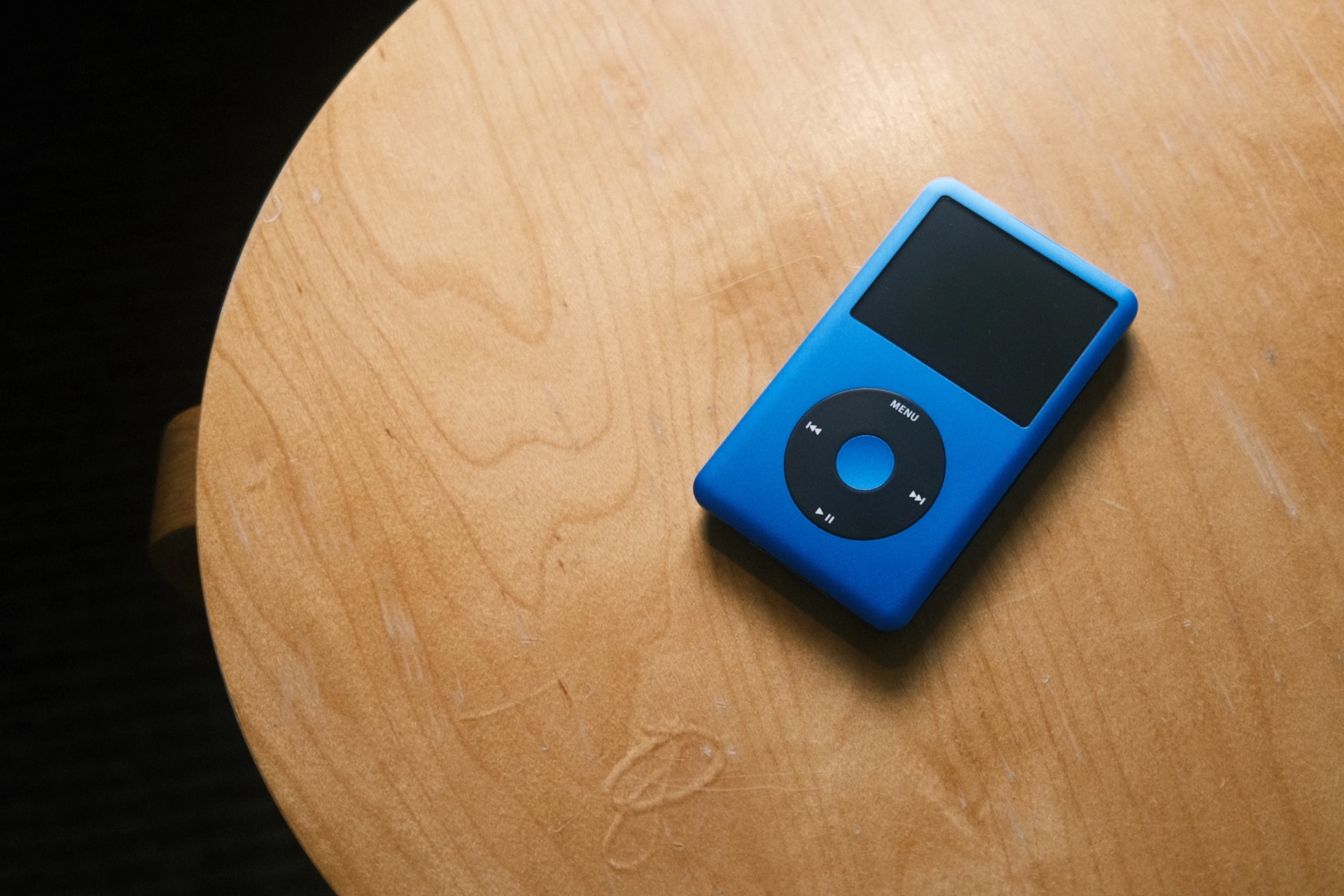 A custom iPod Classic with black clickwheel and blue aluminum shell