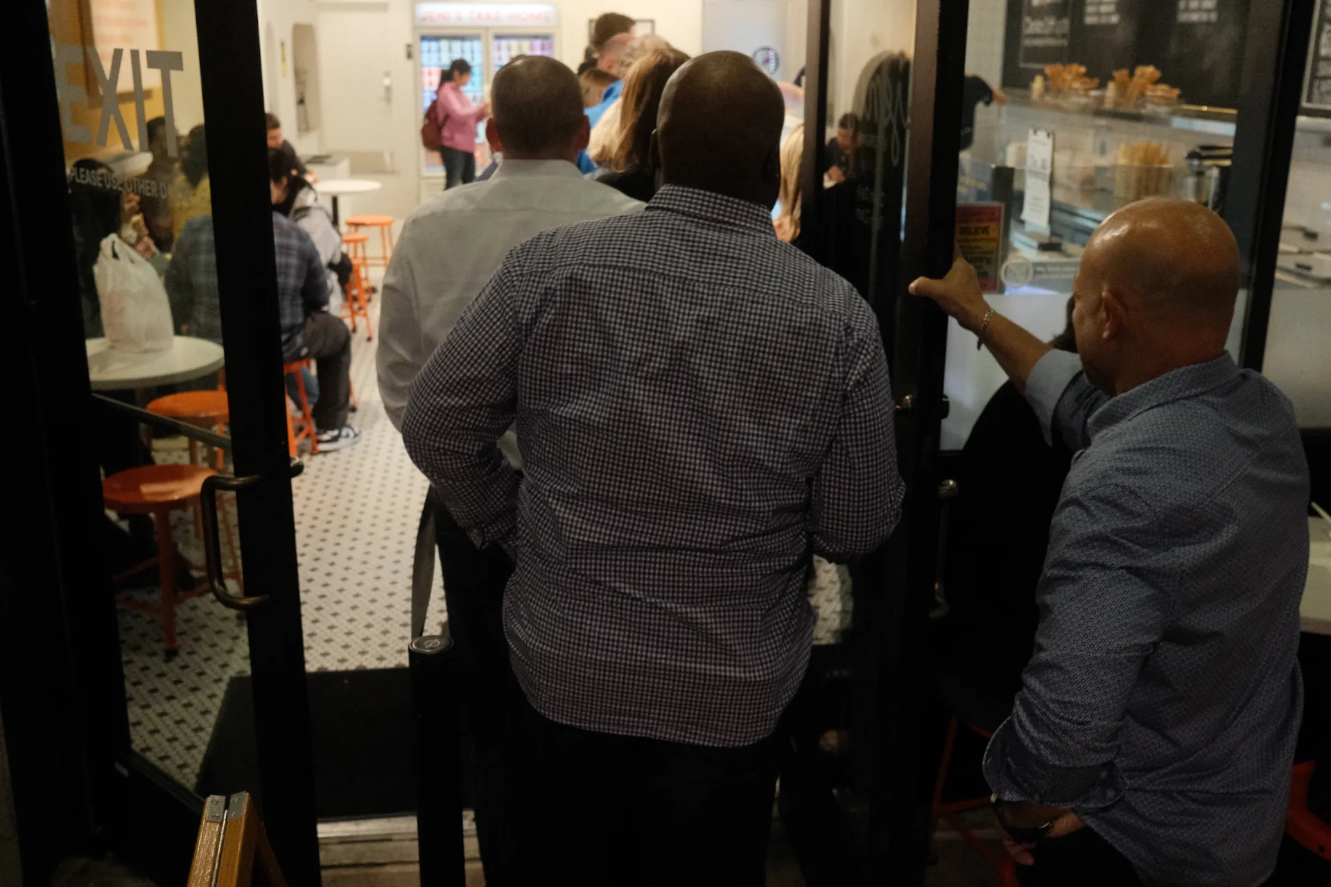 Three guys in line for ice cream